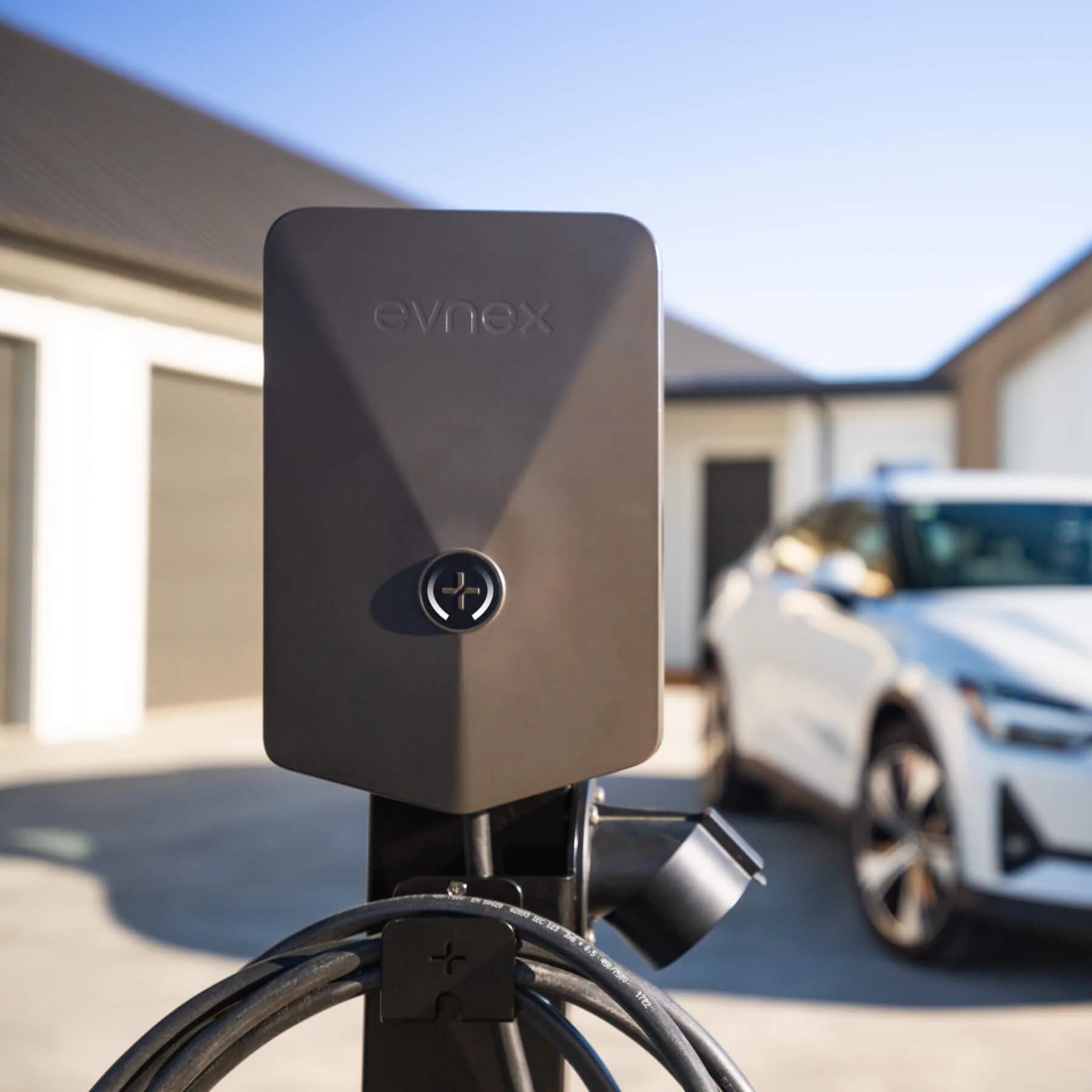 Evnex EV charger mounted outdoors — installed by Gibson Electric